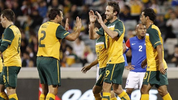 Tall timber ... Josh Kennedy and Lucas Neill celebrate Kennedy's first-half goal.