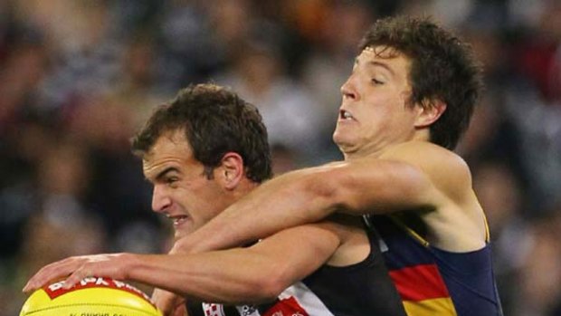Collingwood's John Anthony is tackled by Kurt Tippett of the Crows.