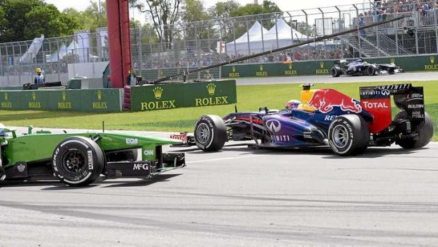 Red Bull driver Mark Webber, right, of Australia collides with Caterham driver Giedo van der Garde of the Netherlands at the hairpin turn during the Canadian Grand Prix in Montreal.