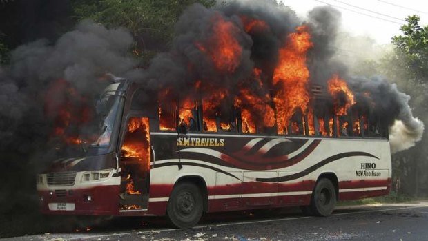 Protest: Activists from the Jamaat-e-Islami party set a bus on fire after the high court ruling.