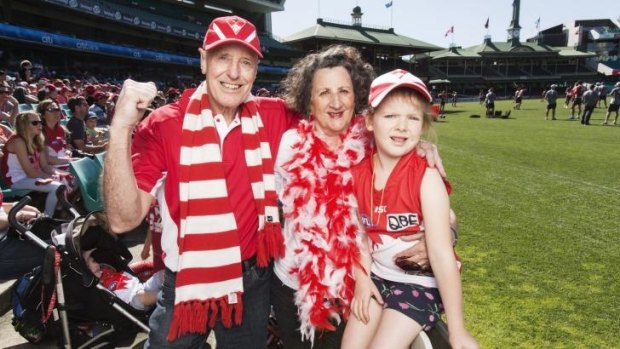 Sydney Swans fans Peter Thomas, his wife Maree and their granddaughter Elena at the team's training session at the SCG.