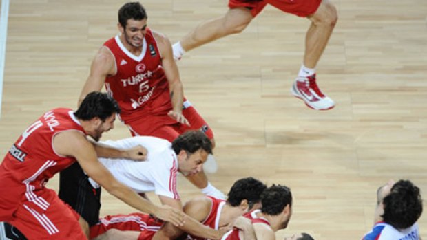 Turkish players react after defeating Serbia 83-82.
