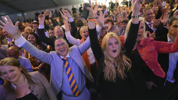 Exuberant ... supporters celebrate after election exit poll results were announced.
