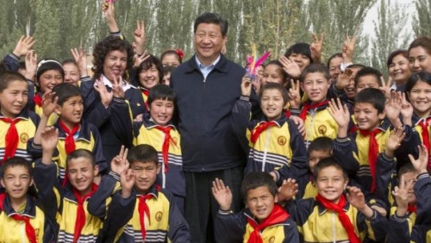 Tough response: China's President Xi Jinping, seen posing with primary school students in Shufu county, Xinjiang, on April 28, has called for decisive action against terrorist acts.