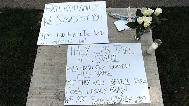 Divisive ... signs line the sidewalk at former Penn State University football coach Joe Paterno's home.