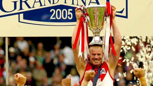 Highs and lows: Barry Hall holds up the premiership cup as Swans captain in 2005.