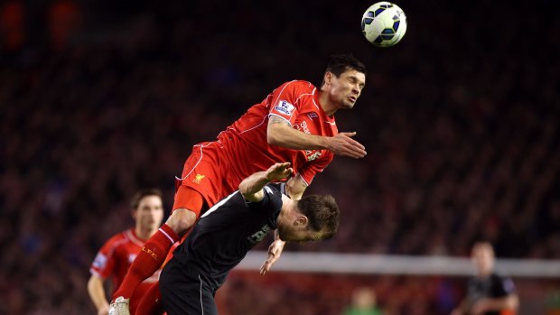 Liverpool's Dejan Lovren out-jumps Burnley's Ashley Barnes.