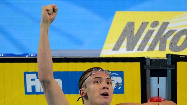 Victory: Robert Hurley raises his fist in triumph after winning the men's 50-metre backstroke final.