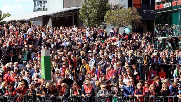 A huge crowd masses at Federation Square to watch the funeral across the road.