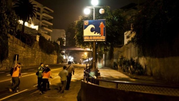 People start evacuating after a tsunami alert in Lima.