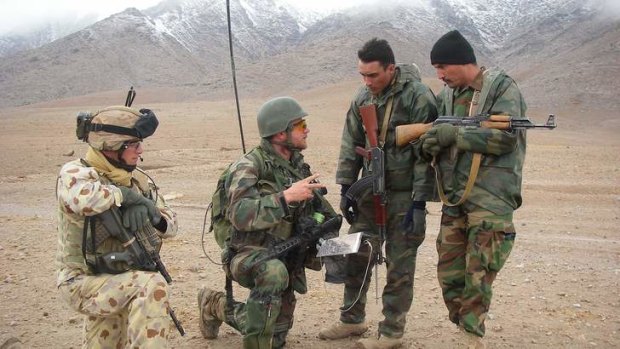 Australian and Dutch military personnel with an Afghan soldier.