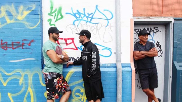 Wall of fame &#8230; Australian centre Greg Inglis, left, greets Anthony Mundine, with father Tony Mundine, outside Newcastle's Tuffn'Up boxing gym before tomorrow's New Zealand Test.