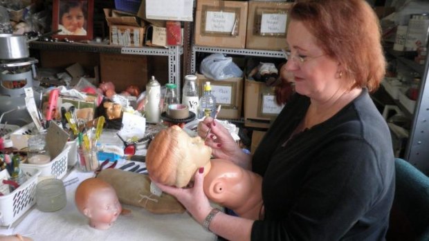 Kerry Stuart, head 'surgeon' at The Doll Hospital in Sydney, works on a celluloid doll, which is her specialty.