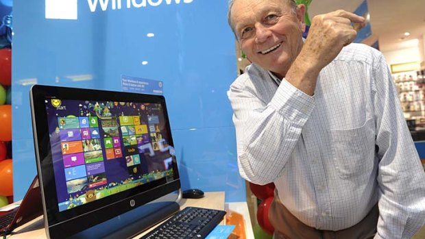 Gerry Harvey poses with a touch-screen desktop Windows 8 computer at the launch in October.