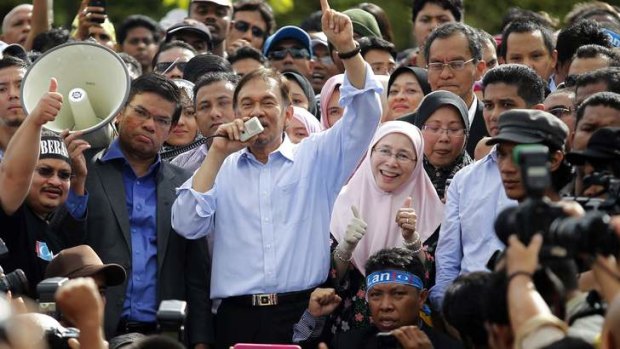 Outrage: The party of Malaysia's opposition leader Anwar Ibrahim, seen speaking at a rally last year, have protested against police brutality.