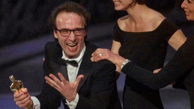 Director and actor Roberto Benigni holds the Oscar he won for <i>Life Is Beautiful</i> in 1999.