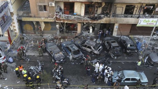 Lebanese army soldiers and forensic inspectors gather to examine the site of an explosion in the southern suburbs of the Lebanese capital Beirut.