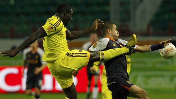 Anzhi Makhachkala's Christopher Samba (left) fights for the ball with Liverpool's Joe Cole.