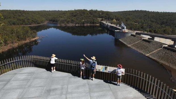 A family enjoying the view of the dam from a platform at the Warragamba Dam Visitor Centre.