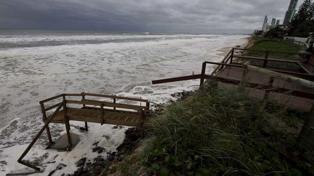 The ocean laps at stairs which have collapsed into the sea at Main Beach on Tedder Avenue on Friday.