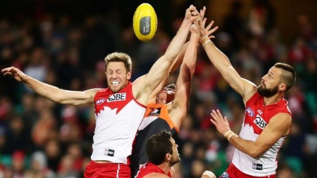 Jermemy Laidler, left, and Nick Malceski, right, of the Swans compete for the ball during the round 15 AFL match between the Sydney Swans and the Greater Western Sydney Giants.