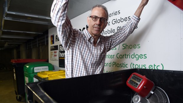 Gordon Streight opens one of the e-waste bins at the recycling depot in the underground car park at The Bauhaus apartment block in Pyrmont. 