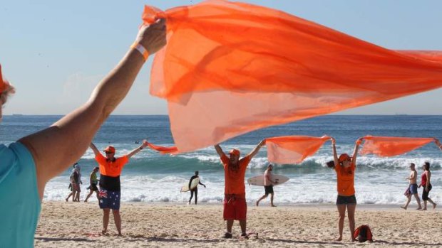 Thanks: Hundreds of people dressed in orange to form a human sign to spell out "WOW" in support of the State Emergency Service (SES).