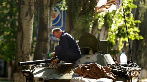 A pro-Russian rebel works on a military vehicle in Slaviansk, eastern Ukraine.
