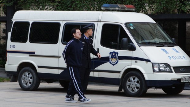Matthew Ng is escorted to court in Guangzhou.