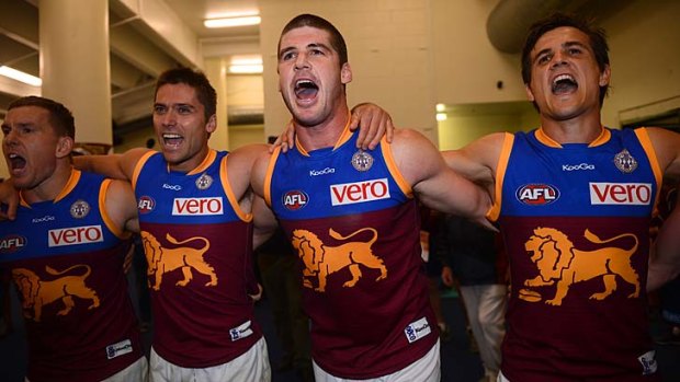Roaring: Skipper Jonathan Brown leads his team in the club song after the Lions stunned the Bombers.