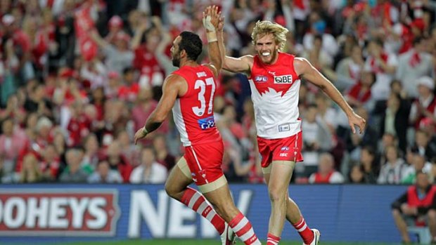 High five ... Adam Goodes and Lewis Roberts-Thomson starred in the Swan's 96-70 victory over Collingwood in the preliminary final at ANZ stadium last night.