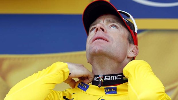 Cadel Evans savours the moment as he dons the leader's yellow jersey on the podium after the 20th stage.