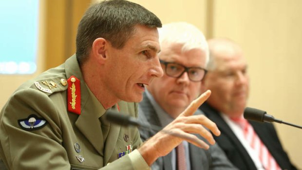Lieutenant-General Angus Campbell, Mark Cormack, deputy secretary Immigration status resolution group and Ken Douglas, first assistant secretary Immigration status resolution group, during the Senate hearing on Friday.