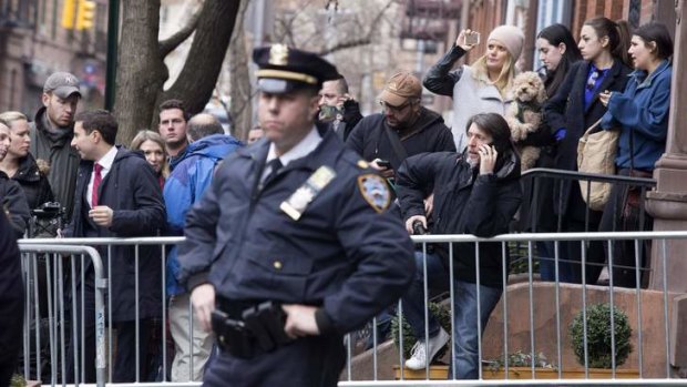 People gather outside the home of Philip Seymour Hoffman.