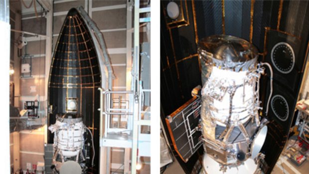 The NASA Wide-field infrared Survey Explorer is shown inside one-half of the nose cone, or fairing, that will protect it during launch.