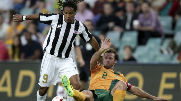 Lucas Neill tackles Costa Rica's Jonathan McDonald.