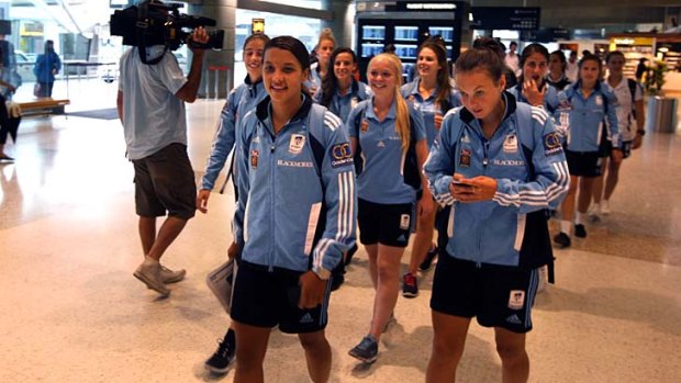 Plenty to celebrate ... the triumphant Sydney FC team returns home after their grand final heroics on Sunday.