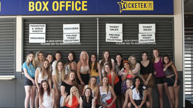 Early fans who were waiting in line pose for a photo at the Brisbane Entertainment Centre hours before One Direction's scheduled performance. 19th of October 2013.