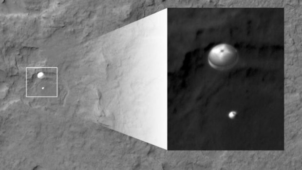 NASA's Curiosity rover and its parachute, left, descend to the Martian surface
