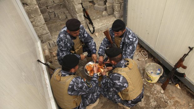 Sunni volunteers who have joined the Iraqi army share a meal on the outskirts of Dohuk province earlier this month.