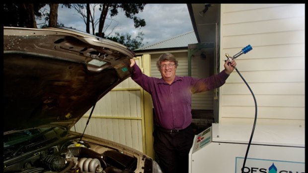 Chris White fills up his Ford using his home-compressed natural gas refuelling system.