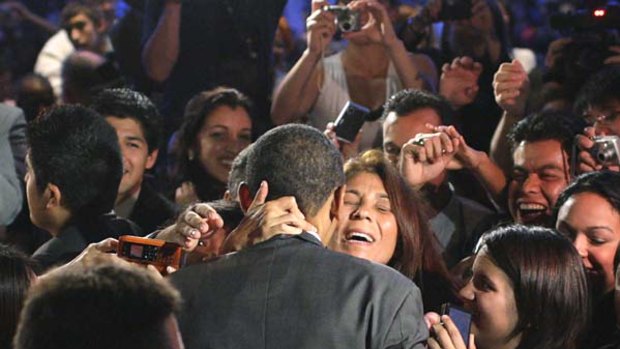 Photo opportunity: A member of the League of United Latin American Citizens embraces Democratic presidential hopeful,  Barack Obama, at the Hispanic advocacy group's national convention in Washington.