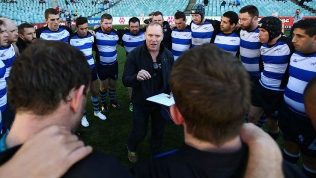 Time to talk tactics: The Sydney Convicts during the half-time break against Macquarie University at Allianz Stadium.