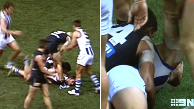 On report .... Chris Judd pulls at Adams' right arm, lifting and twisting it, leaving the Kangaroo midfielder in pain.