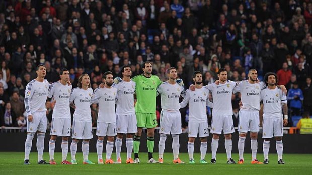 Real Madrid players observe a minute's silence as a mark of respect to Eusebio before the start of the La Liga match against RC Celta de Vigo at the Santiago Bernabeu in Madrid on Monday.