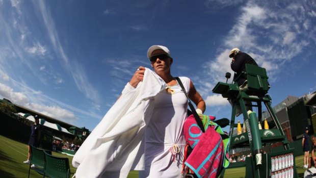 Samantha Stosur walks from the court after being bundled out in the first round at Wimbledon.