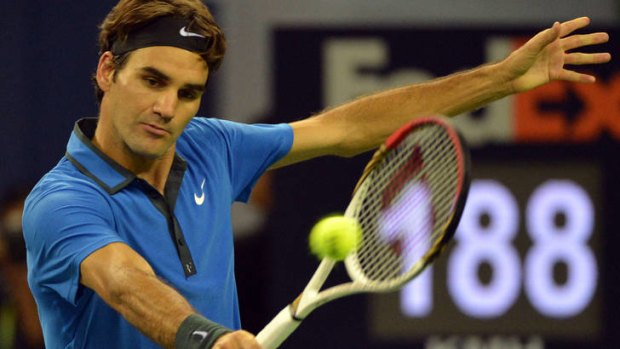 Roger Federer of Switzerland returns a ball before defeating Marin Cilic of Croatia.