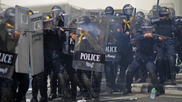 Riot police fire rubber bullets into the crowds of anti-government protesters during a clash in Bangkok, Thailand on Tuesday.