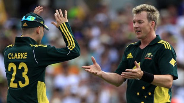 Out for four ... Michael Clarke congratulates Brett Lee on taking the wicket of Ajmal Shahzad.