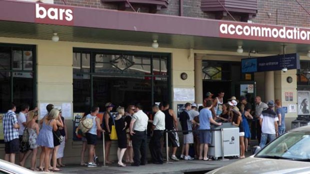 Getting personal ... patrons line up on Australia Day outside the Coogee Bay Hotel where they must agree to have their identification details scanned into a database - and checked against a list of undesirables - before being allowed to enter.